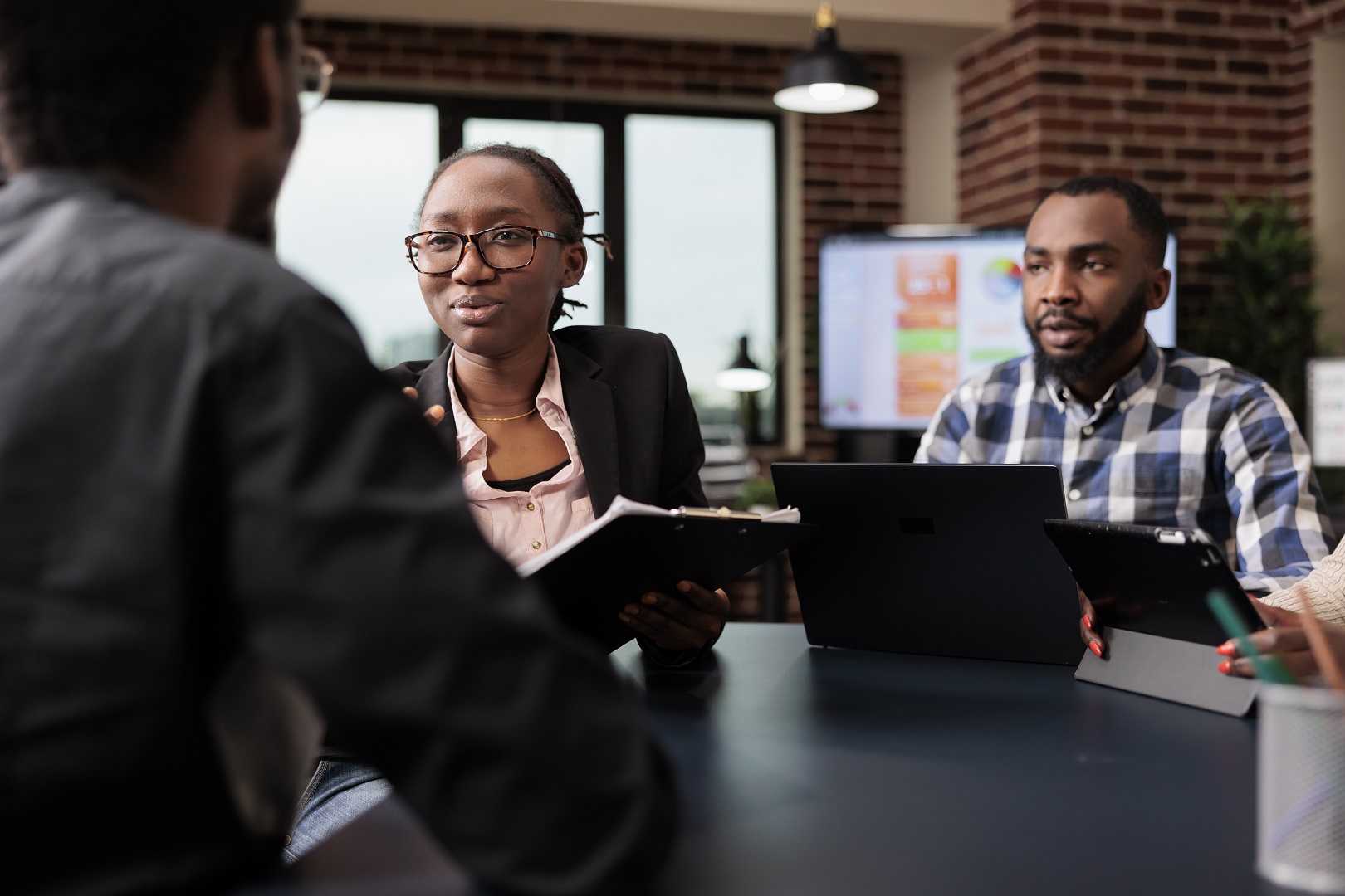 Colleagues team working on company paperwork, doig teamwork to analyze documents and online research information. Planning corporate presentation with data charts, job collaboration.